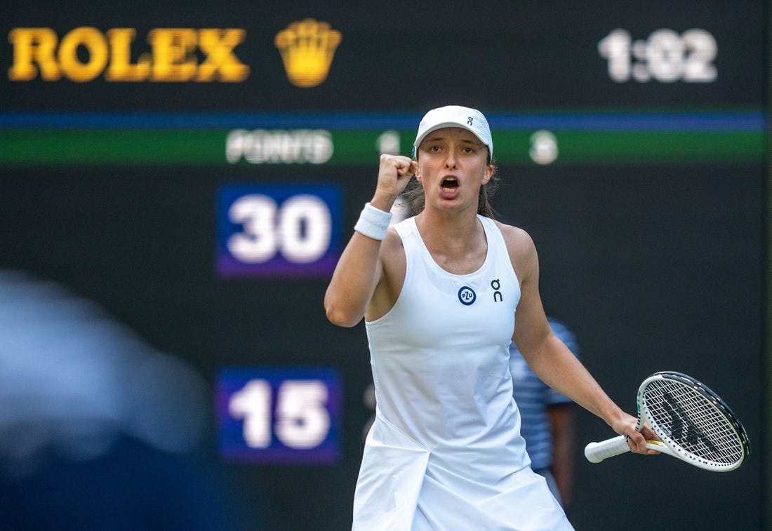 Jul 7, 2023; London, United Kingdom; Iga Swiatek (POL) reacts to a point during her match against Petra Martic (CRO) on day five of Wimbledon at the All England Lawn Tennis and Croquet Club.  Mandatory Credit: Susan Mullane-USA TODAY Sports