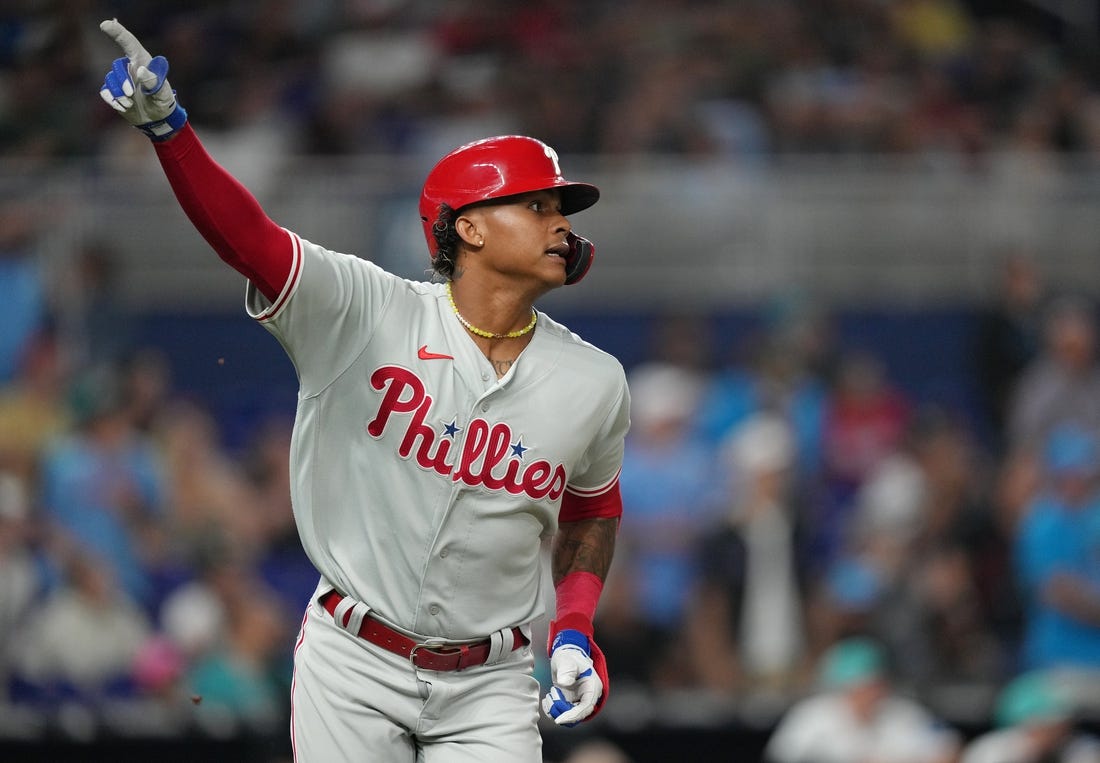 Jul 7, 2023; Miami, Florida, USA; Philadelphia Phillies left fielder Cristian Pache (19) watches his two-run home run clear the wall in the ninth inning against the Miami Marlins at loanDepot Park. Mandatory Credit: Jim Rassol-USA TODAY Sports