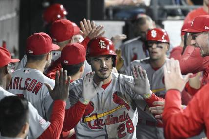 Jul 7, 2023; Chicago, Illinois, USA; St. Louis Cardinals third baseman Nolan Arenado (28) celebrates in the dugout after he hits a two run home run against the Chicago White Sox during the seventh inning at Guaranteed Rate Field. Mandatory Credit: Matt Marton-USA TODAY Sports