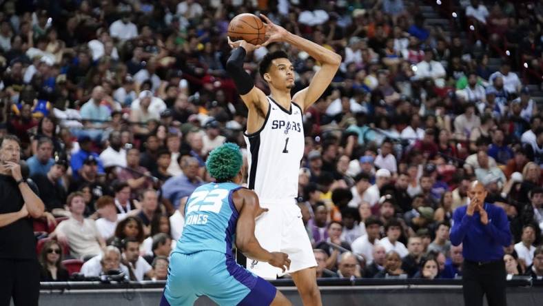 Jul 7, 2023; Las Vegas, NV, USA; San Antonio Spurs forward Victor Wembanyama (1) controls the ball against Charlotte Hornets forward/center Kai Jones (23) during the second half at Thomas & Mack Center. Mandatory Credit: Lucas Peltier-USA TODAY Sports