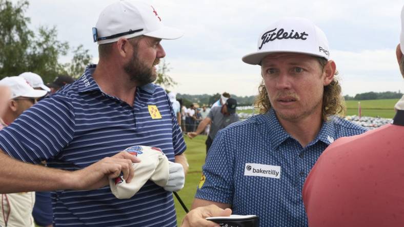 Jul 8, 2023; Hertfordshire, England, GBR; Leaders Cameron Smith (AUS) and Marc Leishman (AUS) practice on the range before the second round of the LIV Golf London golf tournament at Centurion Club. Mandatory Credit: Peter van den Berg-USA TODAY Sports