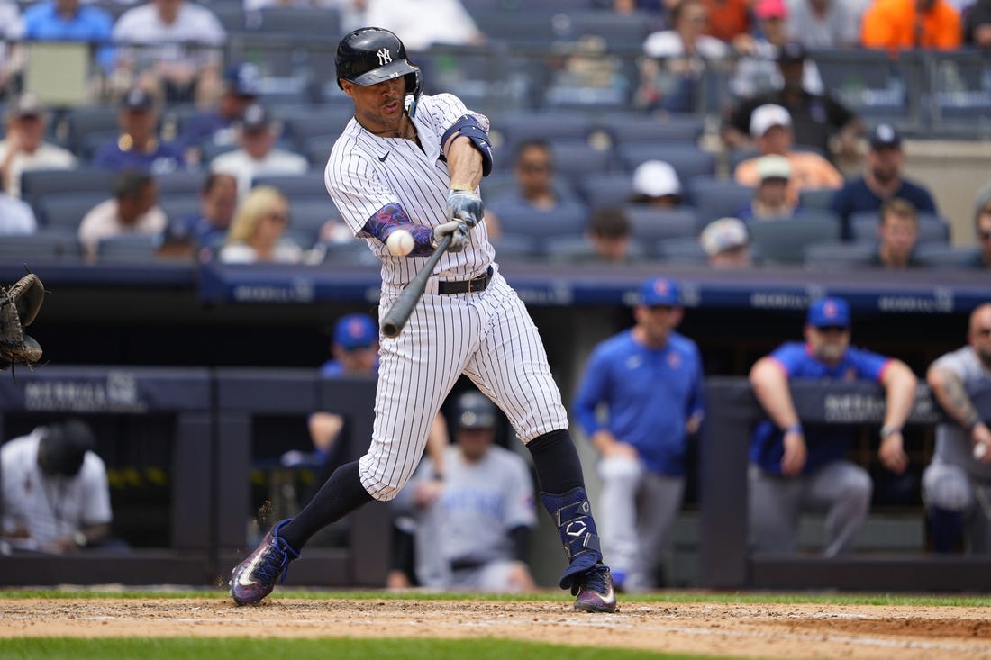 Jul 8, 2023; Bronx, New York, USA; New York Yankees right fielder Giancarlo Stanton (27) hits a two-run homer to right field against the Chicago Cubs during the fifth inning at Yankee Stadium. Mandatory Credit: Gregory Fisher-USA TODAY Sports