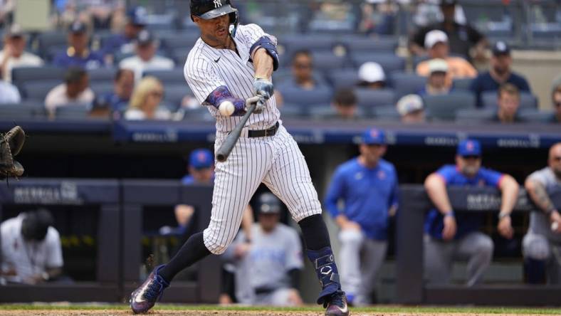 Jul 8, 2023; Bronx, New York, USA; New York Yankees right fielder Giancarlo Stanton (27) hits a two-run homer to right field against the Chicago Cubs during the fifth inning at Yankee Stadium. Mandatory Credit: Gregory Fisher-USA TODAY Sports