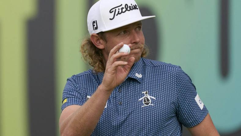 Jul 8, 2023; Hertfordshire, England, GBR; Cameron Smith (AUS) acknowledges the crowd on the 18th green during the second round of the LIV Golf London golf tournament at Centurion Club. Mandatory Credit: Peter van den Berg-USA TODAY Sports