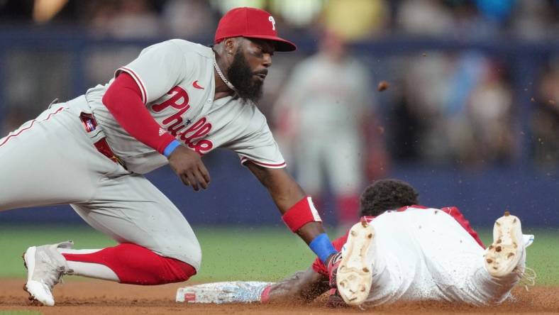 Jul 8, 2023; Miami, Florida, USA; Philadelphia Phillies second baseman Josh Harrison (2) tags out Miami Marlins center fielder Dane Myers (54) at second base in the first inning at loanDepot Park. Mandatory Credit: Jim Rassol-USA TODAY Sports