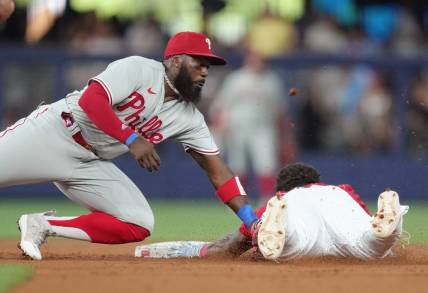 Jul 8, 2023; Miami, Florida, USA; Philadelphia Phillies second baseman Josh Harrison (2) tags out Miami Marlins center fielder Dane Myers (54) at second base in the first inning at loanDepot Park. Mandatory Credit: Jim Rassol-USA TODAY Sports