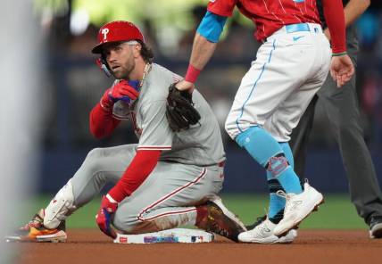 Jul 8, 2023; Miami, Florida, USA;  Philadelphia Phillies designated hitter Bryce Harper (3) takes a moment after hitting a double in the second inning against the Miami Marlins at loanDepot Park. Mandatory Credit: Jim Rassol-USA TODAY Sports