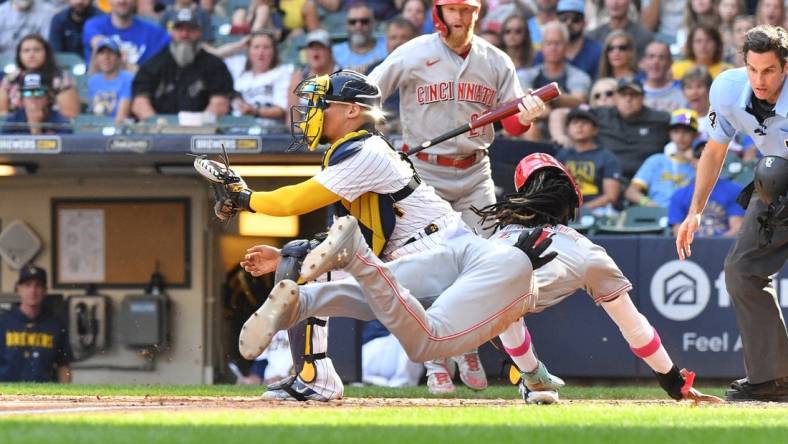 Jul 8, 2023; Milwaukee, Wisconsin, USA; Cincinnati Reds shortstop Elly De La Cruz (44) slides safely into home ahead of the tag by Milwaukee Brewers catcher William Contreras (24) in the seventh inning at American Family Field. Mandatory Credit: Michael McLoone-USA TODAY Sports