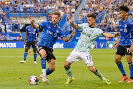 Jul 8, 2023; Montreal, Quebec, CAN; Atlanta United midfielder Amar Sejdic (13) and CF Montreal defender Gabriele Corbo (25) battle for possession during the first half at Stade Saputo. Mandatory Credit: Eric Bolte-USA TODAY Sports