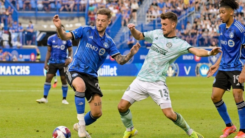 Jul 8, 2023; Montreal, Quebec, CAN; Atlanta United midfielder Amar Sejdic (13) and CF Montreal defender Gabriele Corbo (25) battle for possession during the first half at Stade Saputo. Mandatory Credit: Eric Bolte-USA TODAY Sports