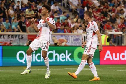 Jul 8, 2023; Harrison, New Jersey, USA; New England Revolution midfielder Brandon Bye (15) celebrates his goal with teammate New England Revolution forward Justin Rennicks (12) during the second half at Red Bull Arena. Mandatory Credit: Vincent Carchietta-USA TODAY Sports
