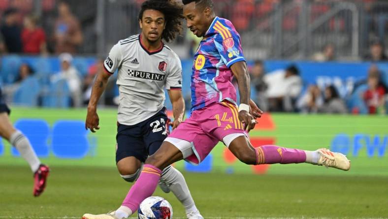 Jul 8, 2023; Toronto, Ontario, CAN;  Toronto FC midfielder Mark-Anthony Kaye (14) shoots the ball past St. Louis City midfielder Aziel Jackson (25) in the first half at BMO Field. Mandatory Credit: Dan Hamilton-USA TODAY Sports