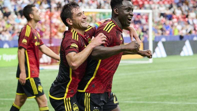 Jul 8, 2023; Vancouver, British Columbia, CAN; Seattle Sounders defender Yeimar Gomez (28) celebrates with midfielder Nicolas Lodeiro (10) after scoring the game winning goal during the second half against the Vancouver Whitecaps at BC Place. Mandatory Credit: Troy Wayrynen-USA TODAY Sports