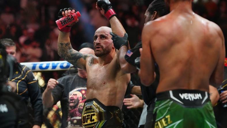 Jul 8, 2023; Las Vegas, Nevada, USA; Alexander Volkanovski (red gloves) reacts after defeating Yair Rodriguez (blue gloves) during UFC 290 at T-Mobile Arena. Mandatory Credit: Stephen R. Sylvanie-USA TODAY Sports