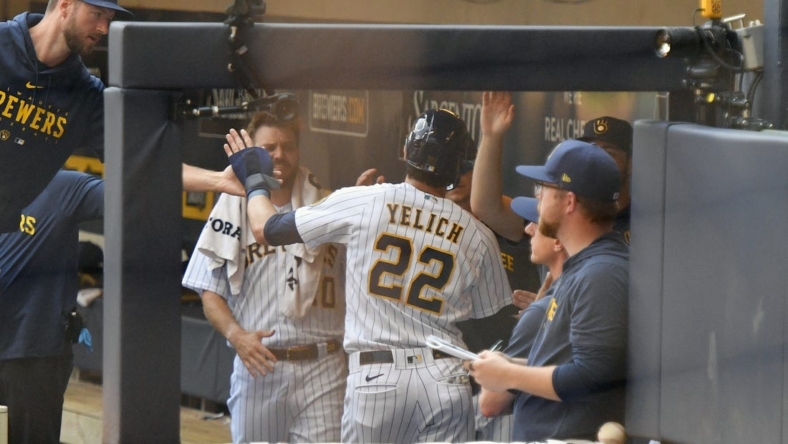 Jul 9, 2023; Milwaukee, Wisconsin, USA; Milwaukee Brewers left fielder Christian Yelich (22) celebrates in the dugout after scoring a run against the Cincinnati Reds in the first inning at American Family Field. Mandatory Credit: Michael McLoone-USA TODAY Sports