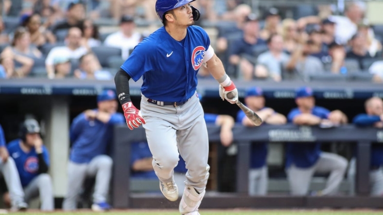 Jul 9, 2023; Bronx, New York, USA;  Chicago Cubs right fielder Seiya Suzuki (27) hits a go ahead RBI sacrifice fly in the eighth inning against the New York Yankees at Yankee Stadium. Mandatory Credit: Wendell Cruz-USA TODAY Sports