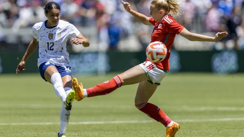 Jul 9, 2023; San Jose, California, USA; United States of America defender Alana Cook (12) passes past Wales midfielder Ceri Holland (7) during the first half at PayPal Park. Mandatory Credit: John Hefti-USA TODAY Sports