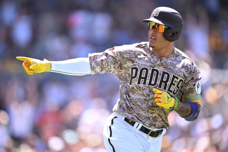 Jul 9, 2023; San Diego, California, USA; San Diego Padres third baseman Manny Machado (13) gestures toward the Padres dugout after hitting a two-run home run against the New York Mets during the fifth inning at Petco Park. Mandatory Credit: Orlando Ramirez-USA TODAY Sports