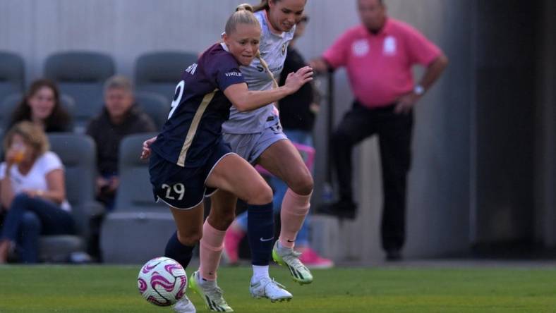 Jul 9, 2023; Los Angeles, California, USA; Angel City FC midfielder Dani Weatherholt (17) and North Carolina Courage forward Millie Farrow (29) battle for the ball during the first half at BMO Stadium. Mandatory Credit: Jayne Kamin-Oncea-USA TODAY Sports