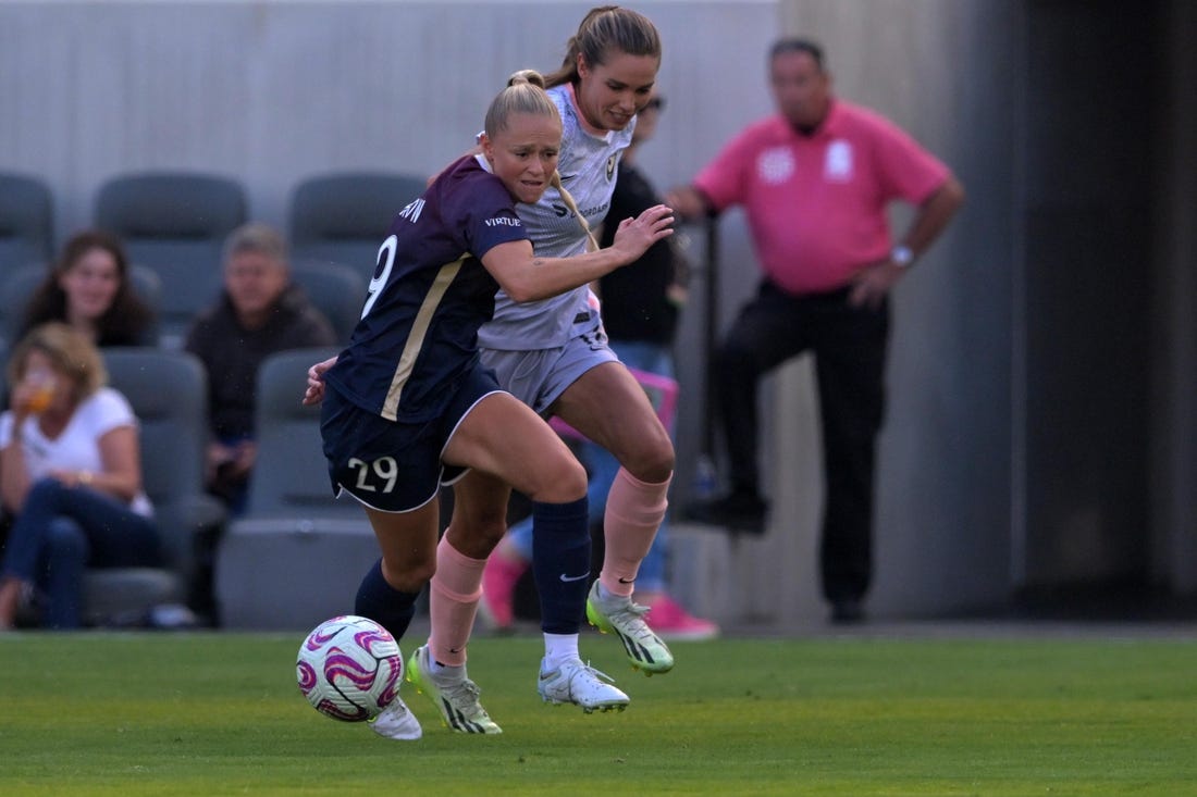 Jul 9, 2023; Los Angeles, California, USA; Angel City FC midfielder Dani Weatherholt (17) and North Carolina Courage forward Millie Farrow (29) battle for the ball during the first half at BMO Stadium. Mandatory Credit: Jayne Kamin-Oncea-USA TODAY Sports