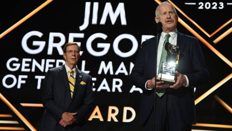 Jun 28, 2023; Nashville, Tennessee, USA; Dallas Stars general manager Jim Nill is awarded the Jim Gregory General Manager of the Year award by Nashville Predators general manager David Poile during the first round of the 2023 NHL Draft at Bridgestone Arena. Mandatory Credit: Christopher Hanewinckel-USA TODAY Sports