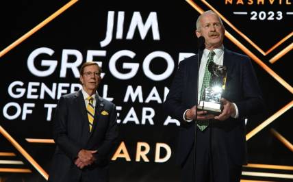 Jun 28, 2023; Nashville, Tennessee, USA; Dallas Stars general manager Jim Nill is awarded the Jim Gregory General Manager of the Year award by Nashville Predators general manager David Poile during the first round of the 2023 NHL Draft at Bridgestone Arena. Mandatory Credit: Christopher Hanewinckel-USA TODAY Sports
