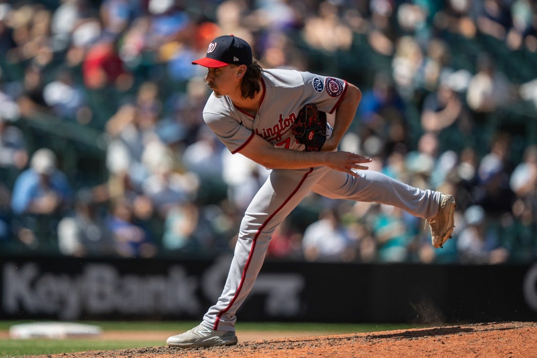 Jun 28, 2023; Seattle, Washington, USA; Washington Nationals reliever Hunter Harvey (73) delivers a pitch against the Seattle Mariners  at T-Mobile Park. Mandatory Credit: Stephen Brashear-USA TODAY Sports