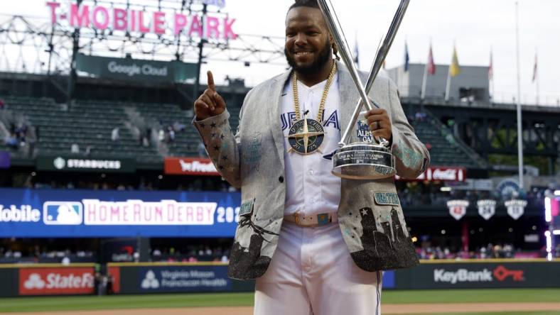 Jul 10, 2023; Seattle, Washington, USA; Toronto Blue Jays first baseman Vladimir Guerrero Jr. (27) celebrates after winning the All-Star Home Run Derby at T-Mobile Park.  Mandatory Credit: Joe Nicholson-USA TODAY Sports