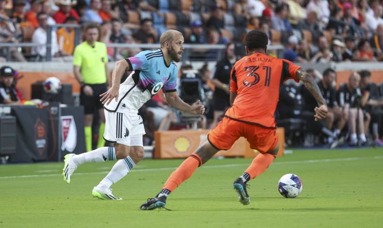 Jul 12, 2023; Houston, Texas, USA; Minnesota United FC forward Teemu Pukki (22) attempts to control the ball as Houston Dynamo FC defender Micael (31) defends during the first half at Shell Energy Stadium. Mandatory Credit: Troy Taormina-USA TODAY Sports