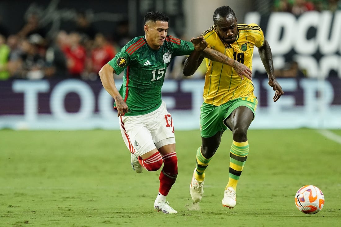 Jul 12, 2023; Las Vegas, Nevada, USA; Mexico forward Uriel Antuna (15) battles for the ball against Jamaica forward Michail Antonio (18) during the first half at Allegiant Stadium. Mandatory Credit: Lucas Peltier-USA TODAY Sports