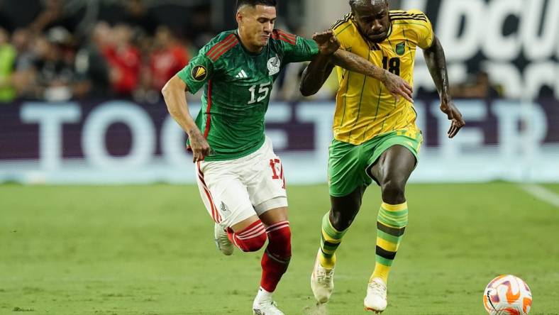 Jul 12, 2023; Las Vegas, Nevada, USA; Mexico forward Uriel Antuna (15) battles for the ball against Jamaica forward Michail Antonio (18) during the first half at Allegiant Stadium. Mandatory Credit: Lucas Peltier-USA TODAY Sports