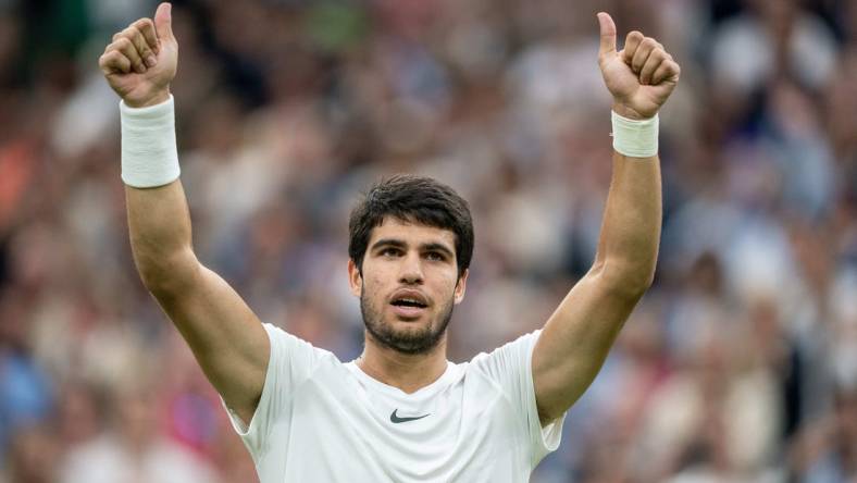 Jul 14, 2023; London, United Kingdom; Carlos Alcaraz (ESP) celebrates winning his match against Daniil Medvedev on day 12 at the All England Lawn Tennis and Croquet Club.  Mandatory Credit: Susan Mullane-USA TODAY Sports