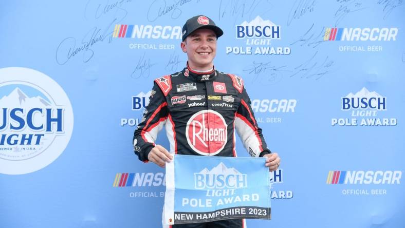 Jul 15, 2023; Loudon, New Hampshire, USA;NASCAR Cup Series driver Christopher Bell (20) celebrates winning the #1 pole position for the Crayon 301 at New Hampshire Motor Speedway. Mandatory Credit: Eric Canha-USA TODAY Sports