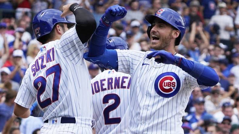 Jul 15, 2023; Chicago, Illinois, USA; Chicago Cubs center fielder Cody Bellinger (24) is greeted by right fielder Seiya Suzuki (27) after hitting a grand slam home run against the Boston Red Sox during the third inning at Wrigley Field. Mandatory Credit: David Banks-USA TODAY Sports