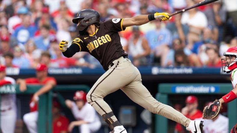 Jul 15, 2023; Philadelphia, Pennsylvania, USA; San Diego Padres right fielder Fernando Tatis Jr. (23) hits an RBI fielders choice during the first inning against the Philadelphia Phillies at Citizens Bank Park. Mandatory Credit: Bill Streicher-USA TODAY Sports