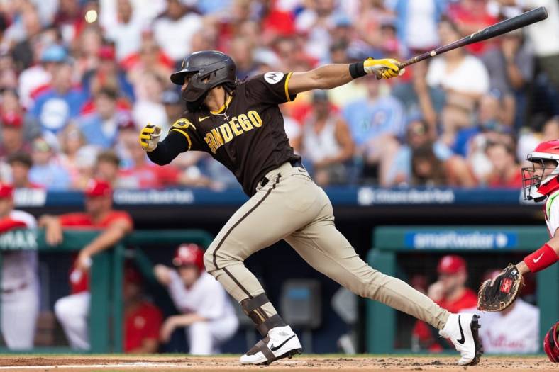 Jul 15, 2023; Philadelphia, Pennsylvania, USA; San Diego Padres right fielder Fernando Tatis Jr. (23) hits an RBI fielders choice during the first inning against the Philadelphia Phillies at Citizens Bank Park. Mandatory Credit: Bill Streicher-USA TODAY Sports