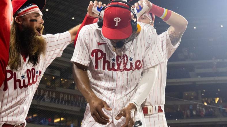 Jul 15, 2023; Philadelphia, Pennsylvania, USA; Philadelphia Phillies outfielder Johan Rojas (18) has water dumped on him by center fielder Brandon Marsh (16) and second baseman Bryson Stott (5) after a victory against the San Diego Padres at Citizens Bank Park. Mandatory Credit: Bill Streicher-USA TODAY Sports