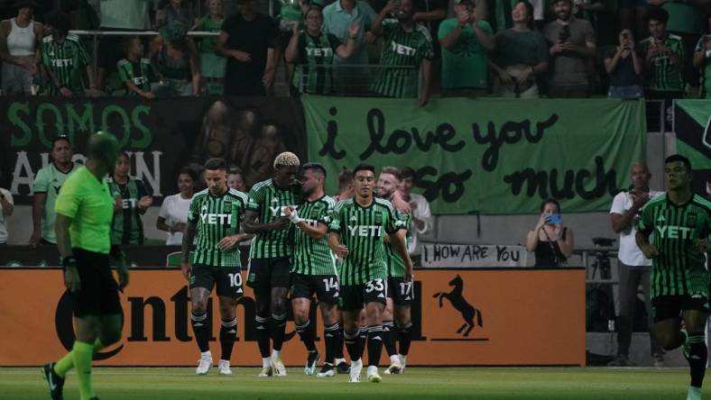 Jul 15, 2023; Austin, Texas, USA; Austin FC midfielder Ethan Finlay (13) celebrates with teammates after scoring a goal against the Sporting Kansas City during the first half at Q2 Stadium. Mandatory Credit: Scott Wachter-USA TODAY Sports