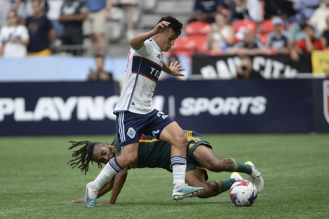 Jul 15, 2023; Vancouver, British Columbia, CAN;  LA Galaxy forward Raheem Edwards (44) battles for the ball against Vancouver Whitecaps FC midfielder Andres Cubas (20) during the first half at BC Place. Mandatory Credit: Anne-Marie Sorvin-USA TODAY Sports