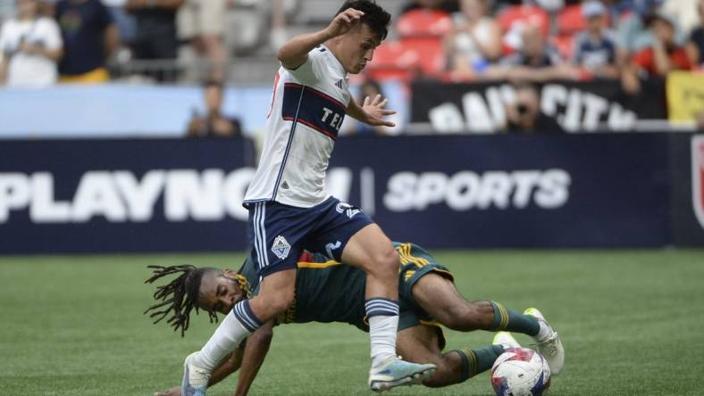 Jul 15, 2023; Vancouver, British Columbia, CAN;  LA Galaxy forward Raheem Edwards (44) battles for the ball against Vancouver Whitecaps FC midfielder Andres Cubas (20) during the first half at BC Place. Mandatory Credit: Anne-Marie Sorvin-USA TODAY Sports