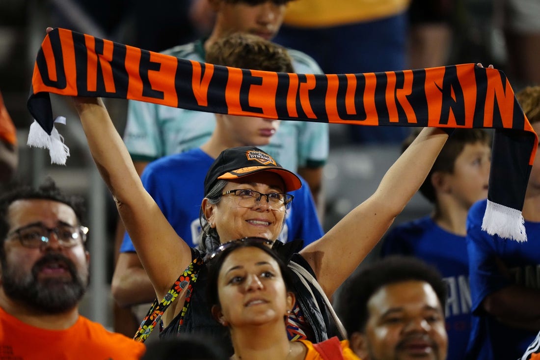 Jul 15, 2023; Commerce City, Colorado, USA; A Houston Dynamo FC fan holds up a scarf to show her support during the game between the Colorado Rapids and Houston Dynamo FC at Dick's Sporting Goods Park. Mandatory Credit: Ron Chenoy-USA TODAY Sports