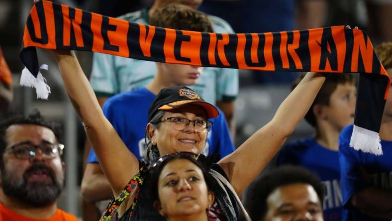 Jul 15, 2023; Commerce City, Colorado, USA; A Houston Dynamo FC fan holds up a scarf to show her support during the game between the Colorado Rapids and Houston Dynamo FC at Dick's Sporting Goods Park. Mandatory Credit: Ron Chenoy-USA TODAY Sports