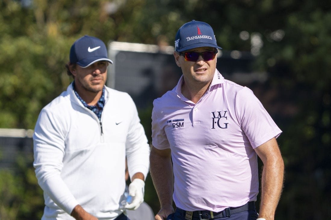 July 17, 2023; Hoylake, ENGLAND, GBR; Brooks Koepka (left) and Zach Johnson (right) watch a tee shot on the fifth hole during a practice round of The Open Championship golf tournament at Royal Liverpool. Mandatory Credit: Kyle Terada-USA TODAY Sports