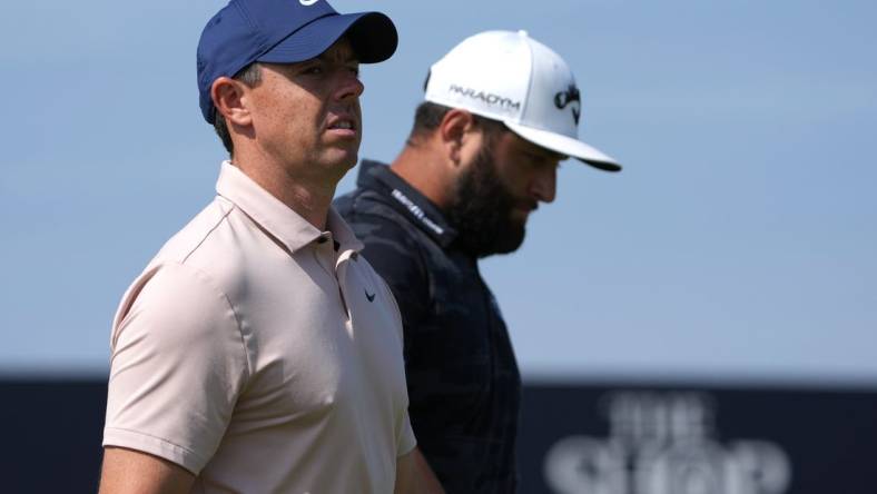 July 20, 2023; Hoylake, England, GBR; Rory McIlroy (left) and Jon Rahm look on during the first round of The Open Championship golf tournament at Royal Liverpool. Mandatory Credit: Kyle Terada-USA TODAY Sports