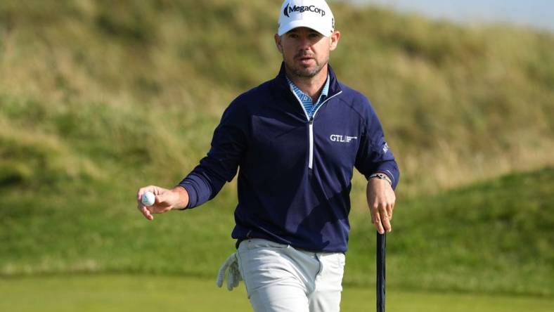 July 20, 2023; Hoylake, England, GBR; Brian Harman acknowledges the crowd after a putt during the first round of The Open Championship golf tournament at Royal Liverpool. Mandatory Credit: Kyle Terada-USA TODAY Sports