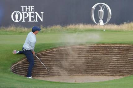 July 20, 2023; Hoylake, England, GBR; Rory McIlroy plays a shot from a bunker on the 18th hole during the first round of The Open Championship golf tournament at Royal Liverpool. Mandatory Credit: Kyle Terada-USA TODAY Sports