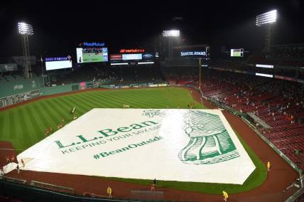 Jul 21, 2023; Boston, Massachusetts, USA;  The Boston Red Sox grounds crew puts the tarp on the field during the fourth inning against the New York Mets at Fenway Park. Mandatory Credit: Bob DeChiara-USA TODAY Sports
