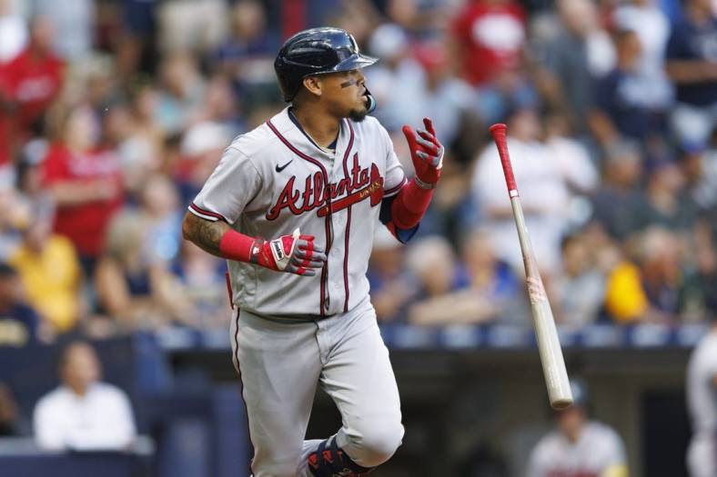Jul 21, 2023; Milwaukee, Wisconsin, USA;  Atlanta Braves shortstop Orlando Arcia (11) flips his bat after hitting a home run during the second inning against the Milwaukee Brewers at American Family Field. Mandatory Credit: Jeff Hanisch-USA TODAY Sports