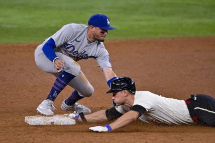 Jul 21, 2023; Arlington, Texas, USA; Texas Rangers shortstop Corey Seager (5) slides under the throw to Los Angeles Dodgers shortstop Miguel Rojas (11) at second base during the eighth inning at Globe Life Field. Mandatory Credit: Jerome Miron-USA TODAY Sports