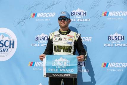 Jul 22, 2023; Long Pond, Pennsylvania, USA; NASCAR Cup Series driver William Byron stands with the Busch Light Pole Award after winning the pole for the HighPoint.com 400 at Pocono Raceway. Mandatory Credit: Matthew O'Haren-USA TODAY Sports